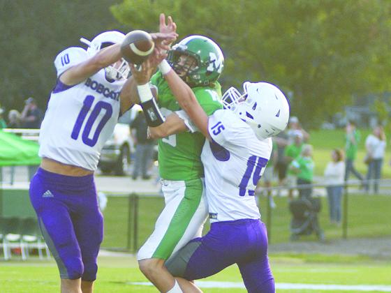 Gilmer High safety Will Kiker (10) and cornerback Kyle Cowart (15) break up a pass in the first half versus Murray County last Friday.