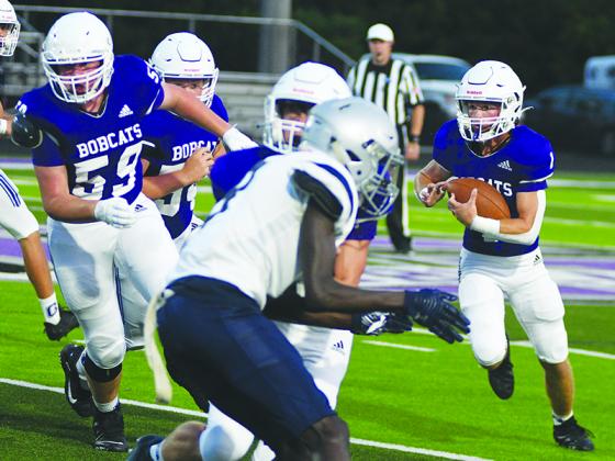 Gilmer High senior halfback Kobe Stonecipher makes his way around the left edge versus East Jackson last Friday. He finished the game with 196 rushing yards and four touchdowns, which included a kickoff return for a score.