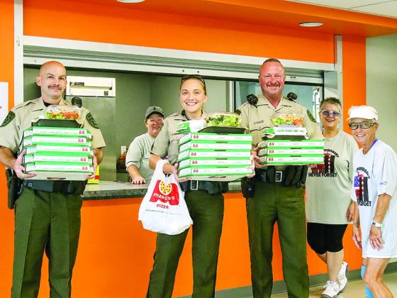 Above, Gilmer Sheriff’s Deputies Scott Camp, Stephanie Pim and Jeff Ellington pick up pizzas for their department from pickleball marathon participants Kelly Buddenhagen, Ruby Boes and Cathy Anderson. (Photos submitted by Ginny Jarvis)