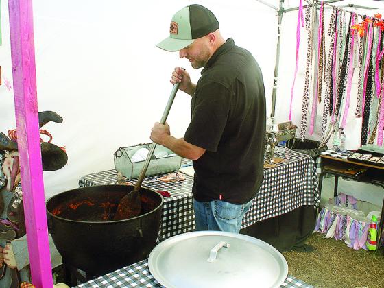Jake Callihan, of The Pink Pig, stirs a good-size pot of the Cherry Log restaurant’s Brunswick stew.