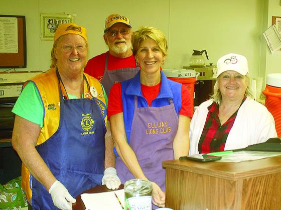 Lions Club members Jan Morris, Cindy Biehl, Charlie Dixon and Karen Dorne were busy serving food at the Lions barn Saturday.