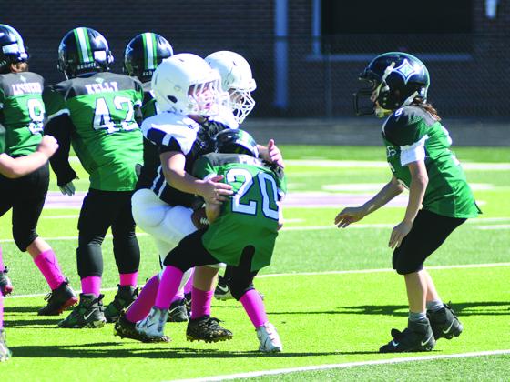 Colton Copeland makes a stop in the backfield during the third-grade game.