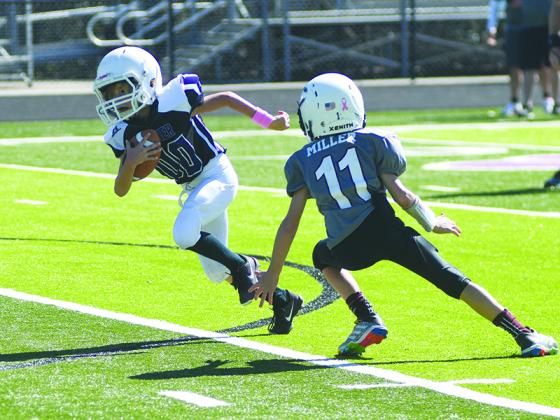 Fourth grader Kamden Becker (00) makes a Chestatee defender miss en route to the end zone.
