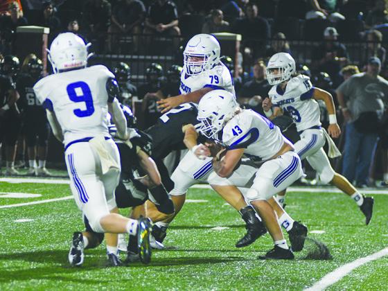 Gilmer fullback Brock Titus looks for running room versus North Hall last Friday as he gets blocks from Dominic Tarantino (9) and Wyatt Ledford (79).