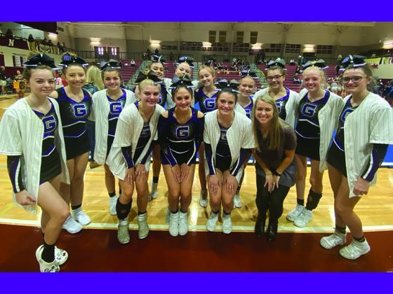 GHS coach Naomi Esparza joins cheerleaders after their third-place finish last Saturday.