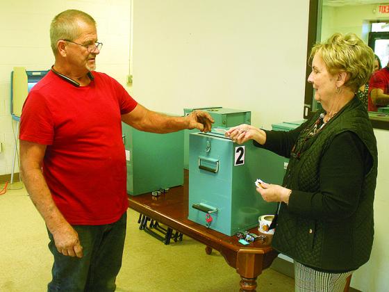 James “Bear” Patterson, left, gets his Georgia Voter sticker from Ellijay Elections Superintendent Sandra Sales after casting a ballot in the city’s Nov. 2 special election.