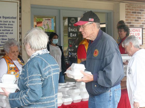 Attending veterans and their family members enjoy a barbecue lunch and dessert served by the Lions Club.