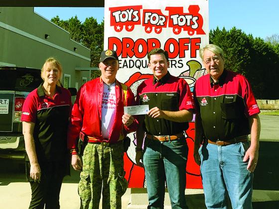 Gilmer Toys for Tots Coordinator A.J. LeCompte, second from left, accepts a donation check from Apple Country Auto Club members Linda Miller, Andrew Miller and Ronnie Prater. 