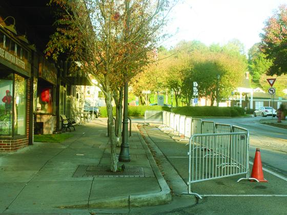 Michael Andrews/ Mountain Life Editor Metal barricades blocking eight parallel parking spaces on River Street are expected to remain up until January. 