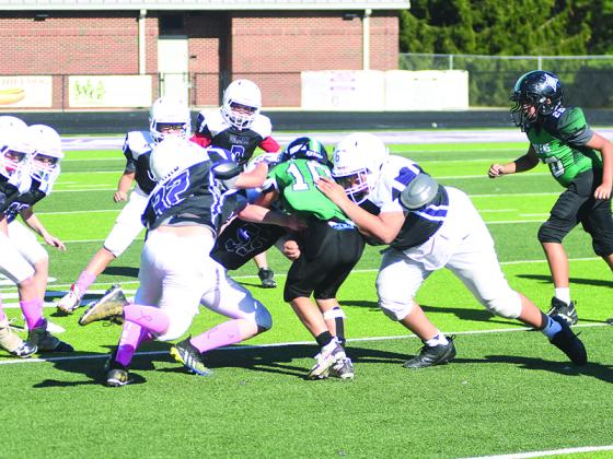 Gilmer’s fifth-grade football players swarm to make a tackle during their last home game and will take the field for the playoffs Nov. 13.