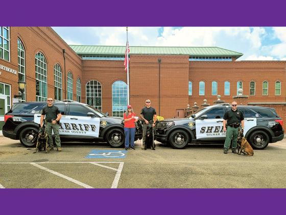 Sylvia Harris, of Friends of the Gilmer Animal Shelter, presents a check used for the Gilmer County Sheriff’s Office K-9 Unit to attend a recent training conference in Perry. Pictured, from left: David Ridings with K-9 Milo, Harris, Blue Patterson with K-9 Arlo and Frank Parks with K-9 Novak.