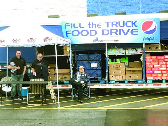 Ellijay Pepsi plant employees Michael Mull, Craig McFarland and Dwight Childers are pictured in front of the East Ellijay Walmart collecting for the plant’s Fill the Truck Food Drive.
