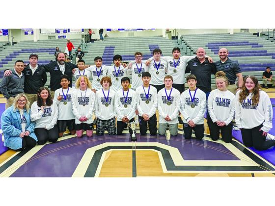 Above are Gilmer High wrestlers, coaches and managers with the Bobcats’ Area-5-3A traditional championship trophy. Twelve of 14 GHS wrestlers won their respective weight class, and include back row from left,  Miguel Jacinto, Diego Jacinto, Daniel Reynoso, Owen Moss, Dylan Galloway and Tony Olea. Front row, are Frisly Ambrocio, Kellen Watts (third), Bregan Berry, Juan Rafael, Arturo Gonzalez, Carson Bentley and Carson Farist. Not pictured, Hunter Brown (fourth place).