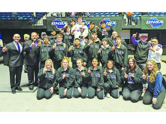 Gilmer High School wrestlers, coaches and managers are pictured with the Class 3A traditional state championship trophy. The Bobcats won the tournament last Friday in Macon, and the championship is the 18th wrestling state title in school history. 