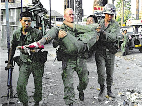 Capt. Bob Reitz carrying wounded South Vietnamese Ranger