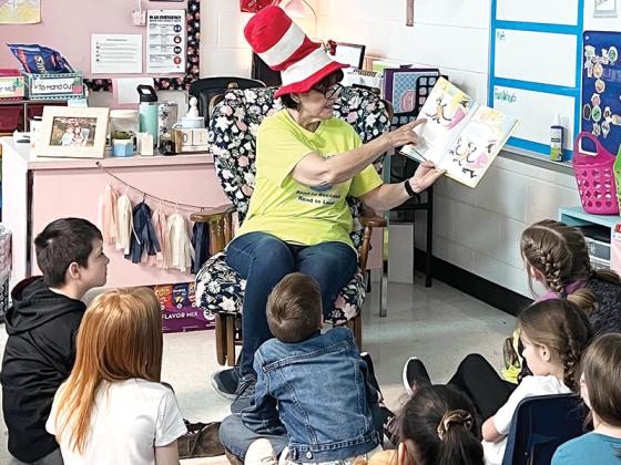Kids Ferst volunteer Eileen Below reads to Gilmer County schoolchildren during a past Dr. Seuss Day.