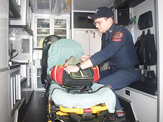 Jonathan Litke, an AEMT with Gilmer Fire and Rescue, checks supplies in back of one of the department’s ambulances. A recent allocation of ARPA funding by East Ellijay will allow Gilmer Fire to put new equipment, including ventilators, on its ambulances. 