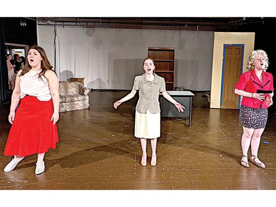 Addie Davenport, Jordan Sharp, and Sophie Burnette rehearse a song from “9 to 5 The Musical,” in which three disgruntled employees kidnap their boss and put themselves in charge of the office. The musical comedy will cap off the 2021-22 season for Gilmer High School Theater this weekend. 