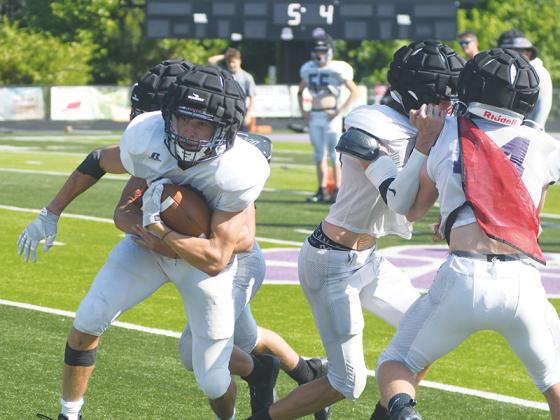 Gilmer High School wingback Will Kiker gets a block from receiver Ian Berry during last Wednesday’s spring football practice.