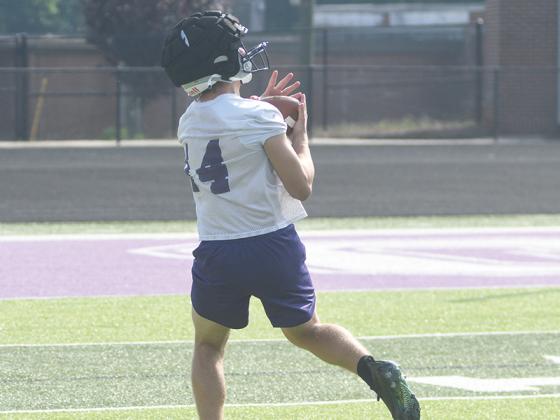 Gilmer High football has sharpened its passing attack during June. Mason Smith (left) hauls in a pass from quarterback Issac Rellinger (below) Monday morning.