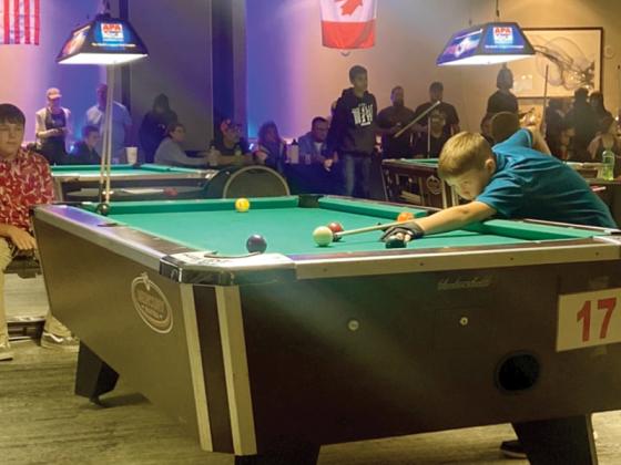 Gauge Crump, 11, lines up a shot during the American Poolplayers Association Junior Championships held earlier this month in St. Louis, Mo. 