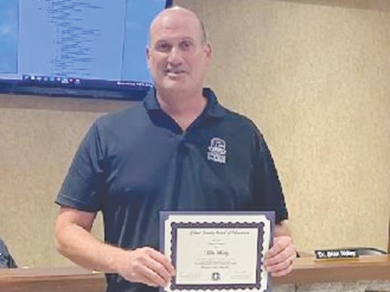 Gilmer County Young Farmer Teacher Mike Bushey is shown with the Golden Key Award, which was recently presented to Gilmer’s agriculture education program at a state conference in Tifton. 