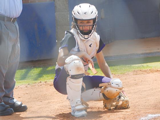 Senior catcher Maddie Wright gets the sign from the dugout last season and is one of three all-region players returning this season.