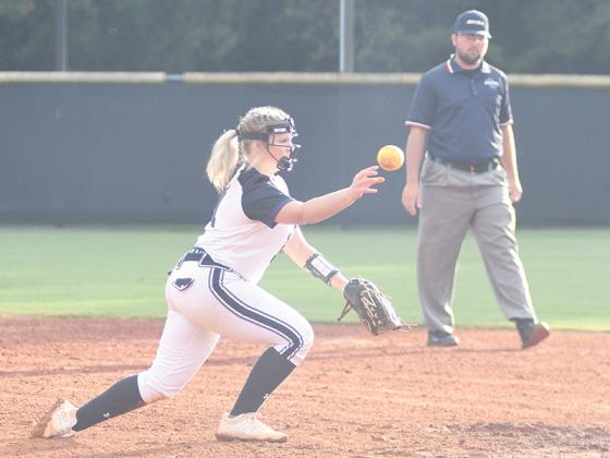 Gilmer High School senior Chesney Mathews throws to first after fielding a ground ball.