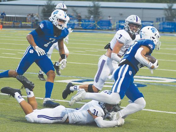 Gilmer Bobcat linebacker Aspen Hataway (31) makes a tackle versus Ringgold as cornerback Hunter Watkins (7) closes in to assist last Friday.