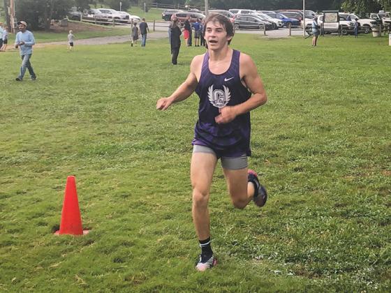 Gilmer Bobcat senior Larz Fowler crosses the finish line at last Tuesday’s 5K in Blairsville.