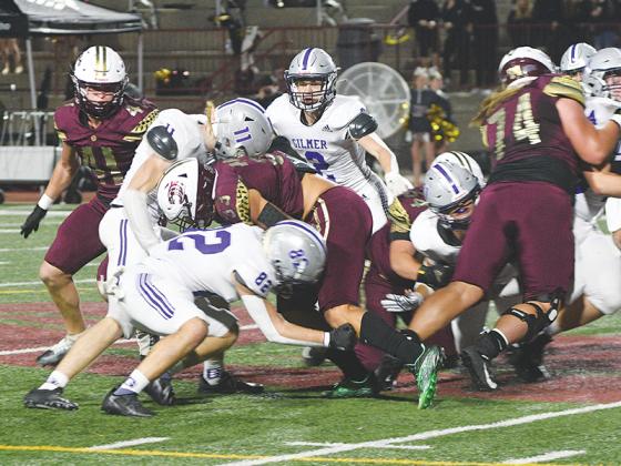 Gilmer High School linebackers Bryson Daniel (82) and Kendall Sanders (11) tackle Dawson County’s Kade Moledor last Friday. 