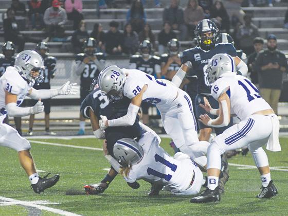 Gilmer’s Kendall Sanders (11) and Ian Berry (28) make a tackle versus West Hall last Thursday. Berry led the GHS defense with nine total tackles and also forced a fumble, recovered a fumble and blocked a punt.