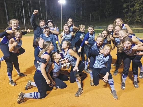 Clear Creek softball players and coaches strike a pose with their championship trophy following the Lady Cats’ 13-4 victory over Lumpkin County last Tuesday. CCMS finished with a 15-1 overall record on the season. 