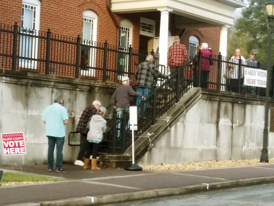 Voters lined up before the 8:30 a.m. opening of the registrar’s office Monday to cast their ballots before the Nov. 7 general election.
