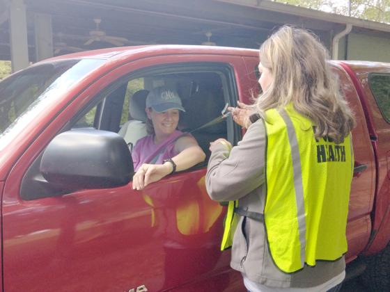 Christy Manning gets her flu shot from nurse Jennifer Vick during the Gilmer Health Department’s drive-thru flu shot clinic at the ETC Pavilion. 