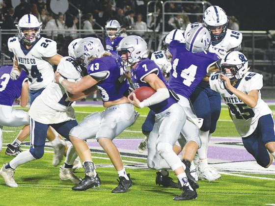 Gilmer’s Hunter Watkins (7) gets blocks from fellow seniors Brock Titus (43) and Mason Smith (14) versus the White County Warriors last Friday. Watkins finished with 113 yards and two touchdowns on nine carries, and he was Gilmer’s leading rusher this season with 958 yards on 90 attempts.