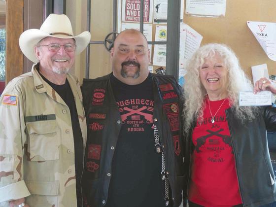 Above, Rick and Lucy Harris accept a donation check to the Noah Harris Foundation from Shane Bowman, of the North Georgia Roughnecks motorcycle group, center. The funds were raised by the Noah Harris Fallen Hero of Georgia Motorcycle Ride, shown below. 