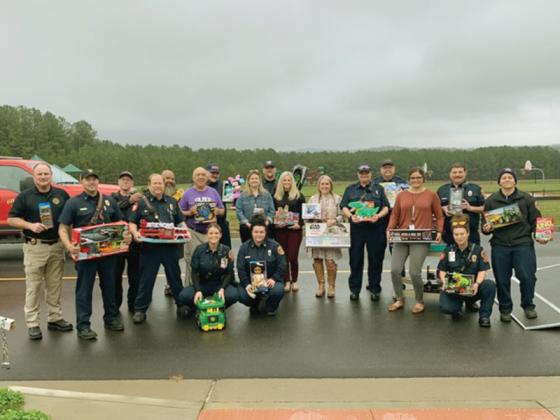 Employees of Gilmer County Fire and Rescue and the Ellijay Fire Department are joined by staff of Clear Creek Elementary School during a recent toy delivery. This year’s Firefighters Kids Christmas effort brought toys and other gifts for students to Ellijay, Clear Creek and Mountain View Elementary School.