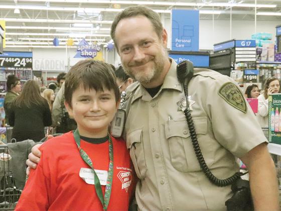 Gilmer County Deputy Zach Weaver and Ethen Richardson were among the public safety professionals and Gilmer school students who partnered up at the East Ellijay Walmart for this year’s Shop With a Hero event. 