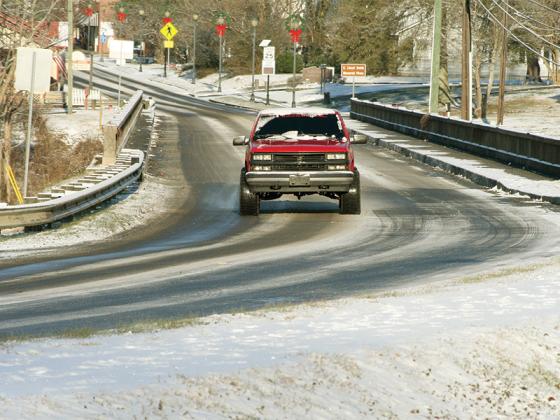 Traffic slowly crossed the BC Logan Memorial Bridge on River Street Tuesday morning after snow fell the night before. (Photo by Michael Andrews/Mountain Life Editor)