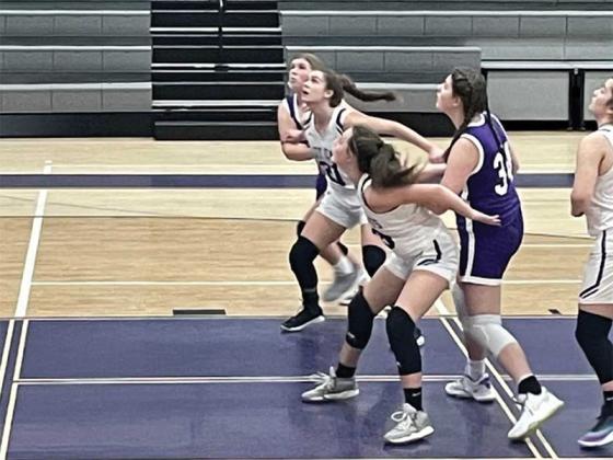Lady Cat eighth graders Jaylee McDaniel (21) and Kenley Thompson get in position to rebound versus the Indians, and Thompson was the top scorer with seven points.