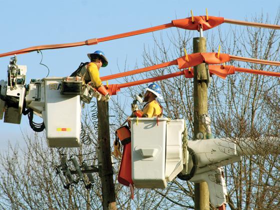 Linemen work to switch Georgia Power service in downtown Ellijay from overhead to underground lines. 