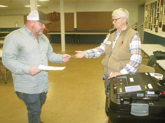 Voter Jaime Ledford, left, is helped by poll worker Jackie Watson during the election for 7th District State House Representative at the Ellijay Northeast (Lions Club) polling place Tuesday, Jan. 3. 