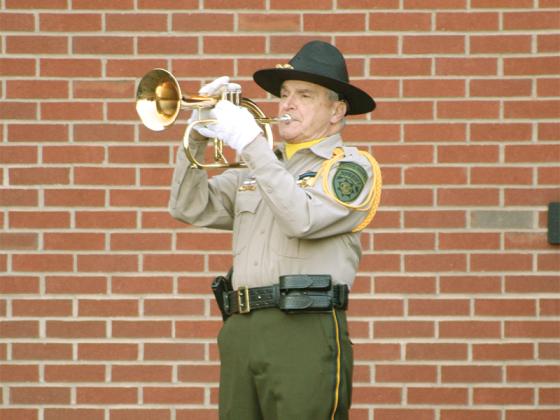 Bugler Bill Hall plays “Taps” to conclude the ceremony.