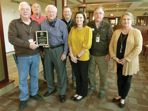 Members of the Gilmer County Board of Assessors and Chief Appraiser Theresa Gooch present a plaque to board member Tom Porter following his last meeting with the assessor board. Porter served 12 years on the board and chose not to seek another term. Pictured, from left: Bill Logan, Jerry Davis, Porter, Gary Engel, Gooch, John Williamson and new assessor board member Lisa Bradley. 