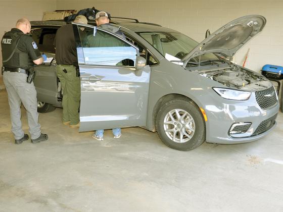 Law enforcement officials search the van used in the burglary of Southern Drug Company in Blue Ridge.