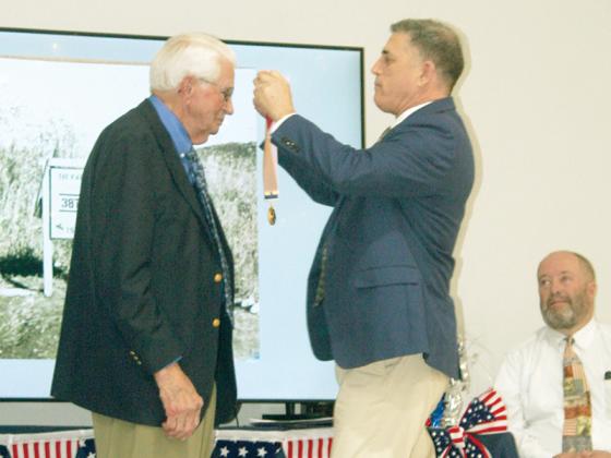 Korean War veteran Otis Suddeth, left, receives the Ambassador of Peace Medal from Ninth District Congressman Andrew Clyde in a ceremony at Cartecay Baptist Church. 