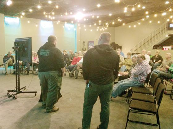 Gilmer Sheriff’s Office Detectives Dan Farnham, left, and Trevor Stanfield, right, gave examples and advice about different types of scams during a recent workshop at the Orchard Church.