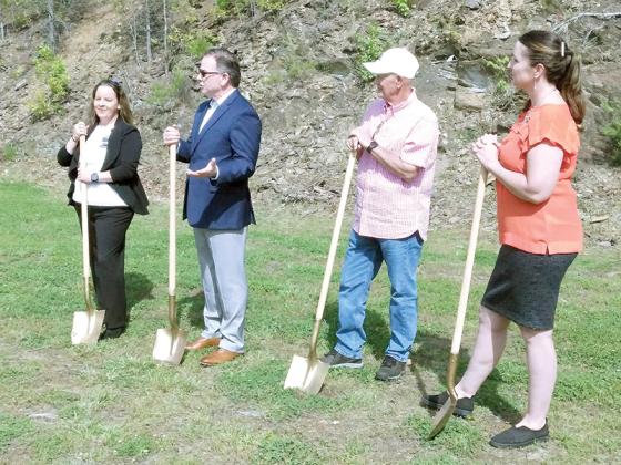 At a groundbreaking event, Dr. William Raisig, second from left, describes the purpose of a new aquatic center that will be constructed behind the Raisig Clinic and Wellness Center in East Ellijay. Pictured, from left: Raisig Clinic Assistant Director Sandy Bowling, Dr. Raisig, East Ellijay Mayor Don Callihan and Gilmer Chamber CEO Jennifer Grimmer.    