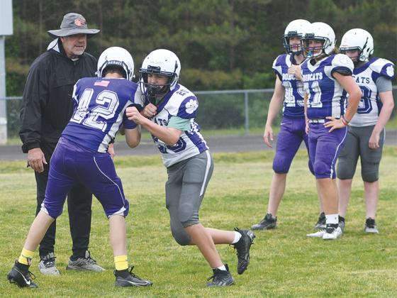 Clear Creek Middle School concluded spring football practice last Friday. Above, head coach Willie Dodaro observes players shedding oncoming blockers, while players (below) participate in an Oklahoma drill.